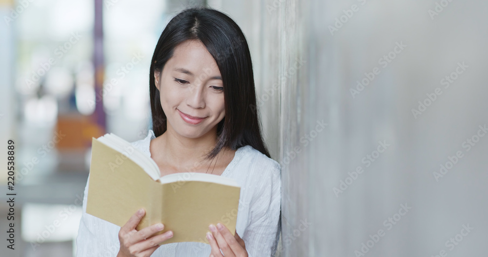 Woman read on book in university campus Woman read on book in university campus