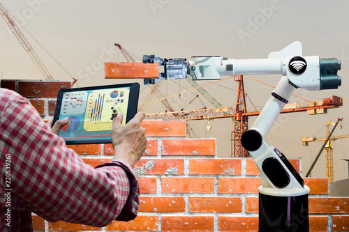 Man holding a tablet Remote control Smart robot industry 4.0 arm brick building construction human force remote wifi