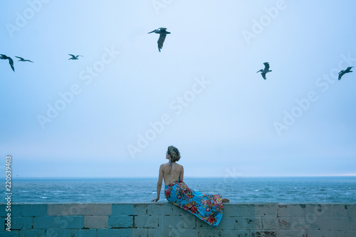 woman in dress in front of ocean
