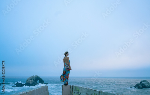woman in dress in front of ocean