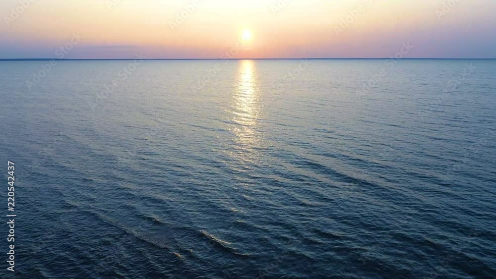 The flight above the water on the picturesque sunrise background. drone shot The flight above the water on the picturesque sunrise background. drone shot