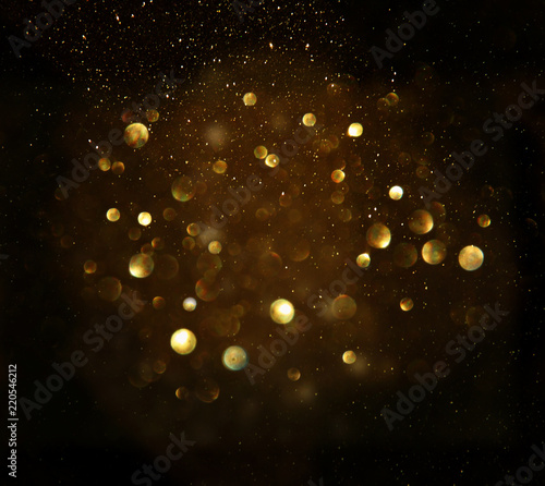 glitter vintage lights background. black and gold. de-focused. © tomertu