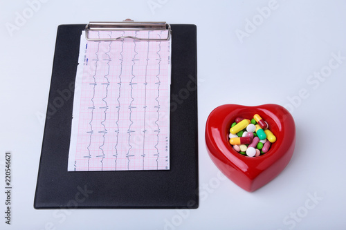 RX prescription, Red heart, asorted pils and a stethoscope on white background photo