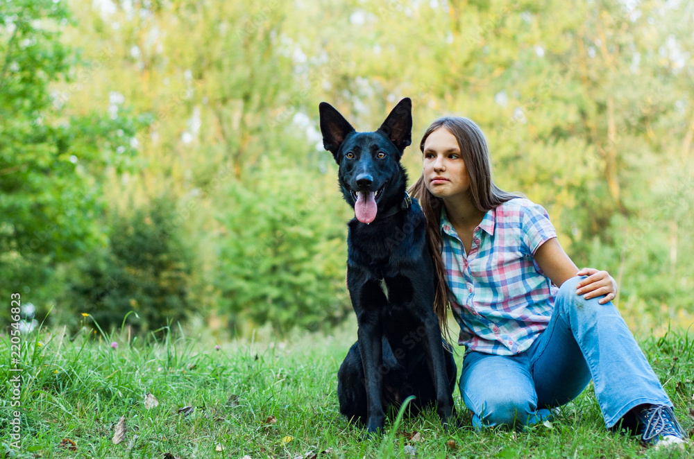 Portrait of young teenage girl with a shepherd dog in the park outdoor Portrait of young teenage girl with a shepherd dog in the park outdoor