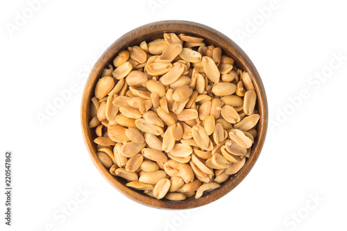Roasted peanuts in wooden bowl isolated on white background.