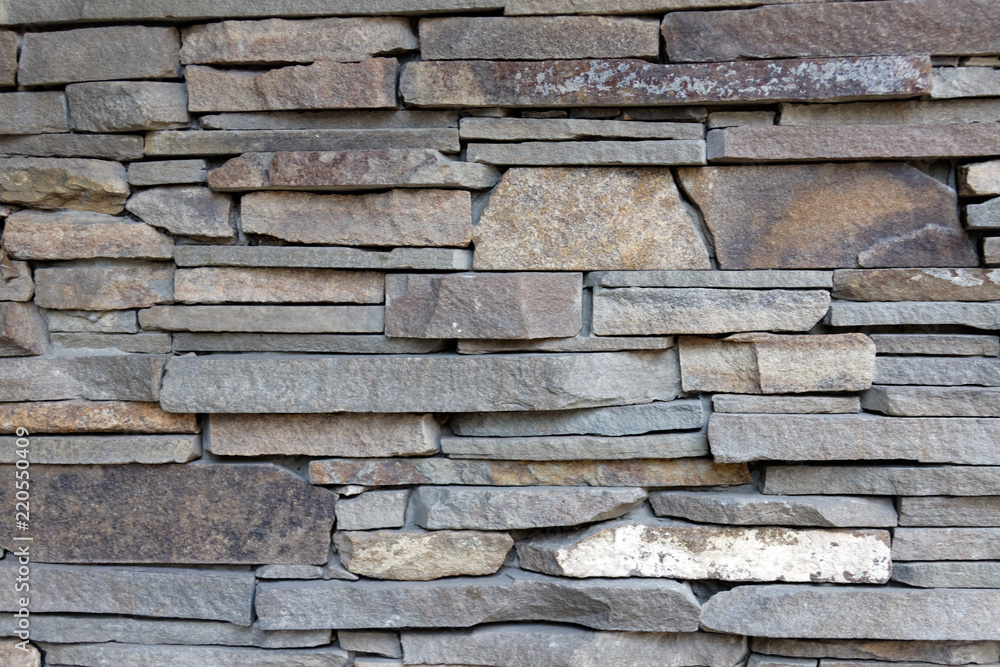 Decorative wall of artificial torn stone. Stone masonry as background or texture. Decorative wall of artificial torn stone. Stone masonry as background or texture.