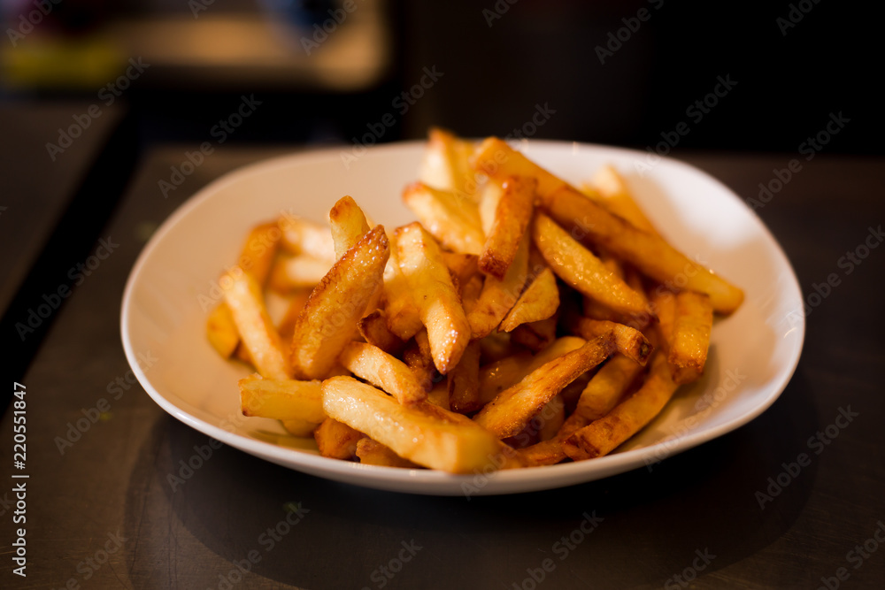 French fries on a plate, isolated on white background. French fries on a plate, isolated on white background.