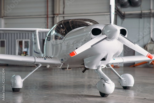 Small private turbo-propeller airplane in hangar