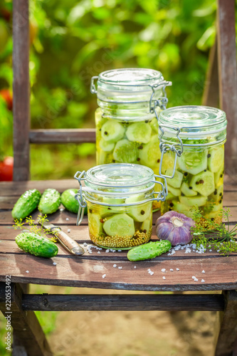 Homemade pickled cucumbers in small summer greenhouse