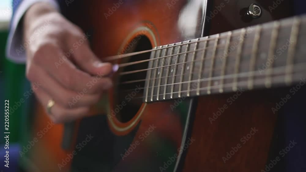 Man's hands playing acoustic guitar, close up Man's hands playing acoustic guitar, close up