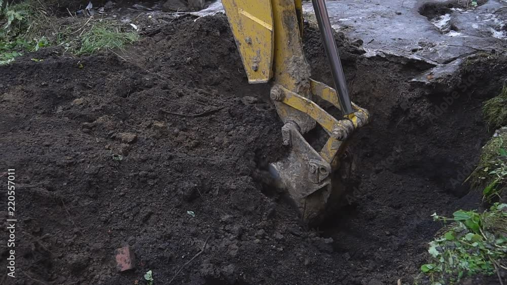 Excavator shovel digs into a ground Excavator shovel digs into a ground