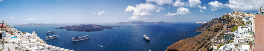 Beautiful panoramic view from touristic Fira town to caldera and volcano and cruise ship at summer sunny day. Santorini Island, Thira, Greece.