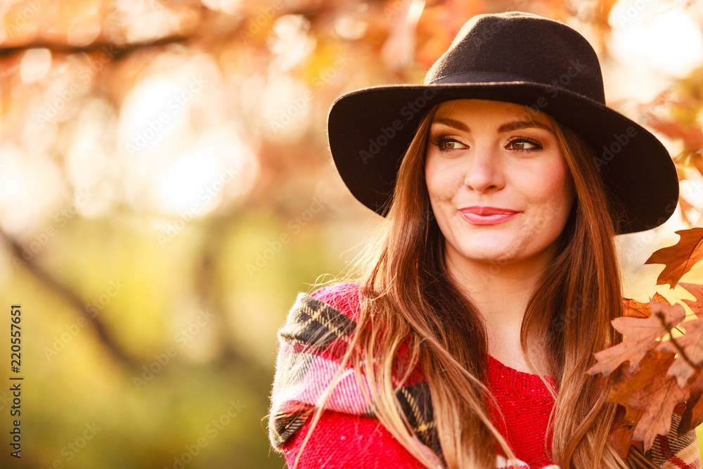 Charming woman walking in autumnal park Charming woman walking in autumnal park