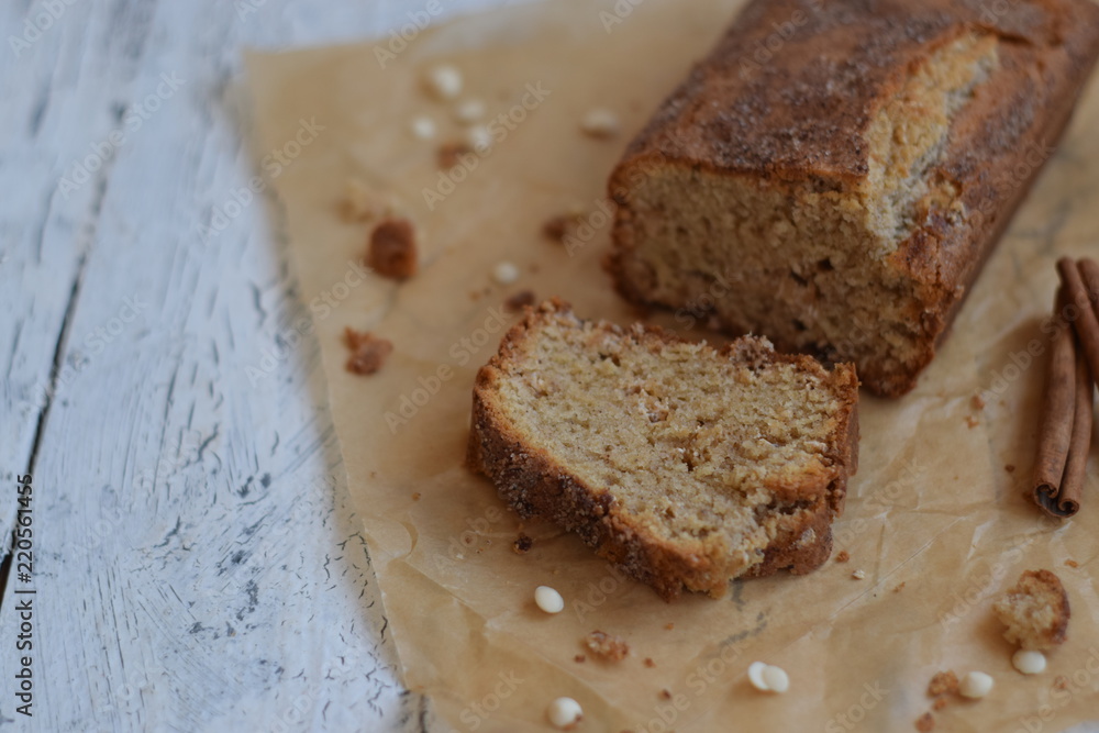 Banana cake with cinnamon and white chocolate on a white wooden background Banana cake with cinnamon and white chocolate on a white wooden background