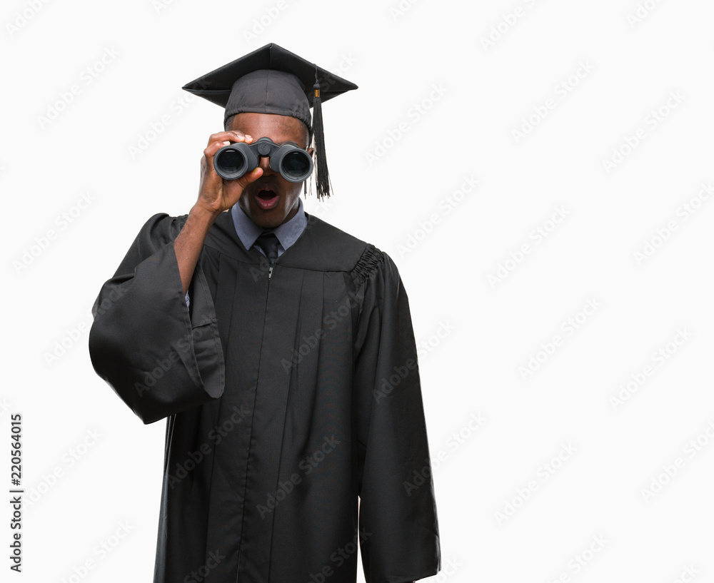 Young graduated african american man looking for a job using binoculars scared in shock with a surprise face, afraid and excited with fear expression Young graduated african american man looking for a job using binoculars scared in shock with a surprise face, afraid and excited with fear expression