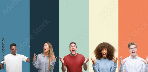 Group of people over vintage colors background crazy and mad shouting and yelling with aggressive expression and arms raised. Frustration concept.