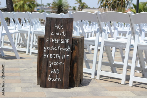 Trendy sign at wedding with seating arrangement