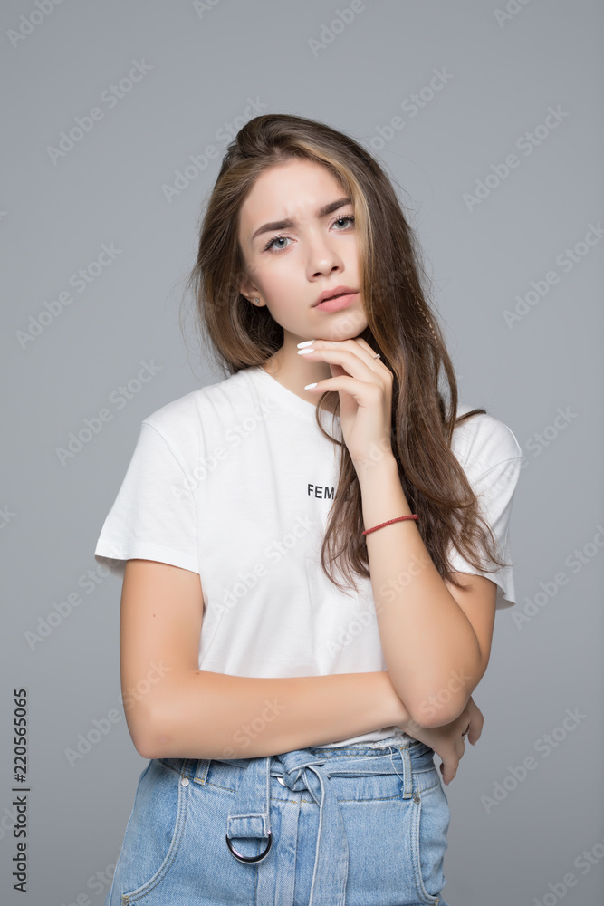 Beautiful young woman in white shirt on grey background Beautiful young woman in white shirt on grey background