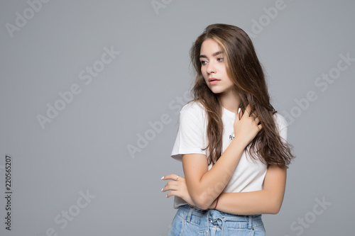 Smiling woman in blank white t-shirt over gray background