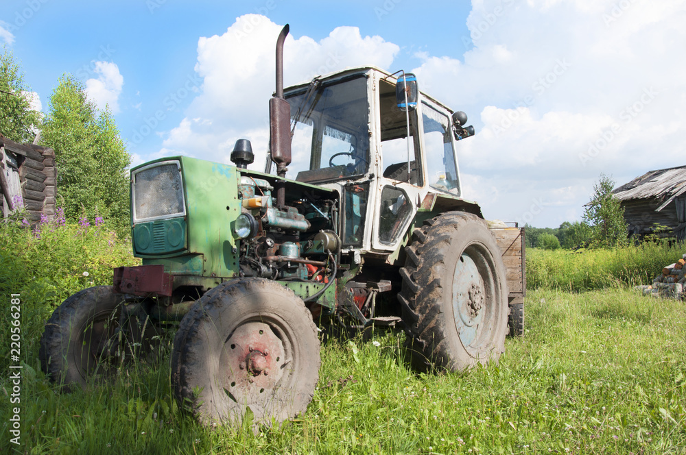 The old wheeled tractor with trailer The old wheeled tractor with trailer