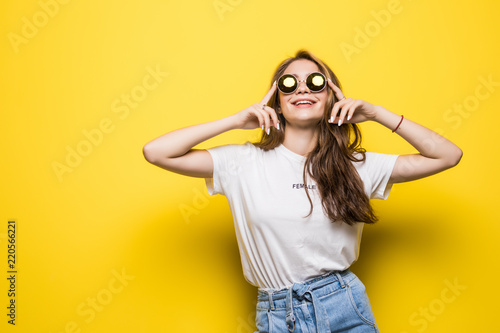 Portrait of smiling beautiful woman in sunglasses against of yellow background. © F8  \ Suport Ukraine