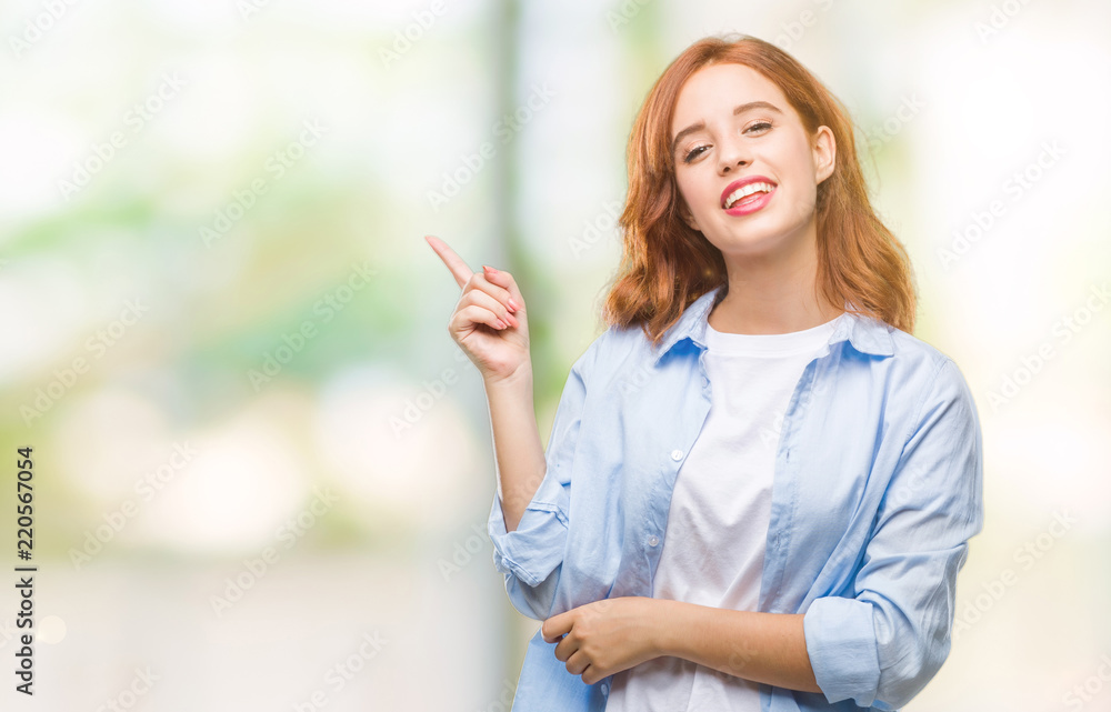 Young beautiful business woman over isolated background with a big smile on face, pointing with hand and finger to the side looking at the camera.