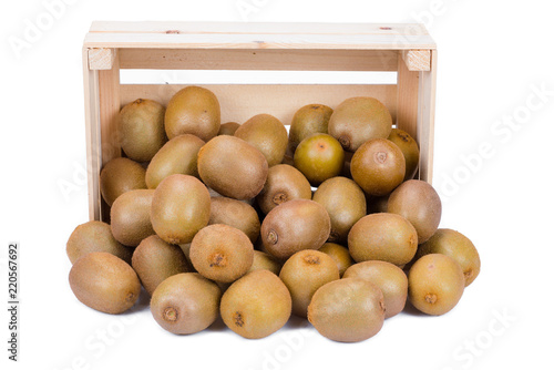 Wooden box with many ripe kiwi fruits in front of it isolated on white background