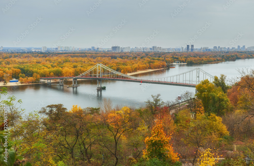 Pedestrian bridge across the Dnieper River, autumn landscape, Kiev