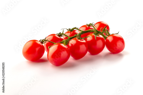 Small cherry tomato on white background. Close-up