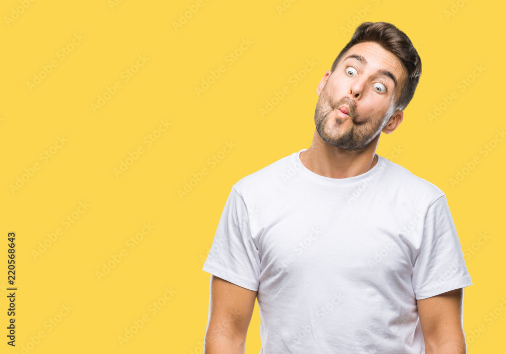 Young handsome man over isolated background making fish face with lips, crazy and comical gesture. Funny expression. Young handsome man over isolated background making fish face with lips, crazy and comical gesture. Funny expression.
