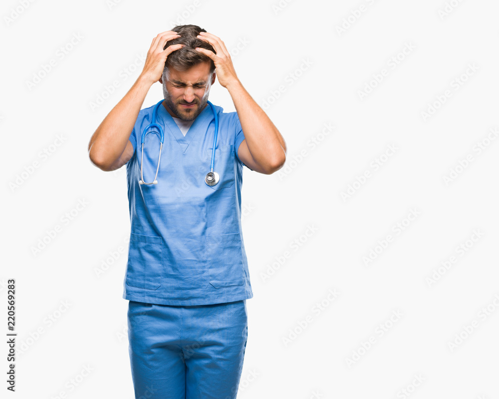 Young handsome doctor surgeon man over isolated background suffering from headache desperate and stressed because pain and migraine. Hands on head. Young handsome doctor surgeon man over isolated background suffering from headache desperate and stressed because pain and migraine. Hands on head.