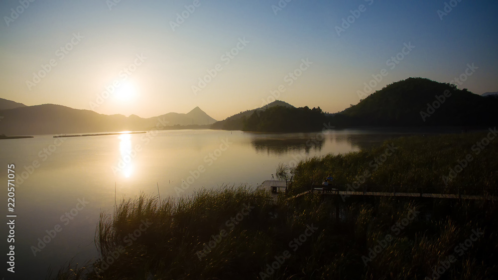 Wonderful the lake with sunrise in the evening. attractively nature landscape of golden lake and lagoon. image for background, wallpaper, copy space, decorate and arts.