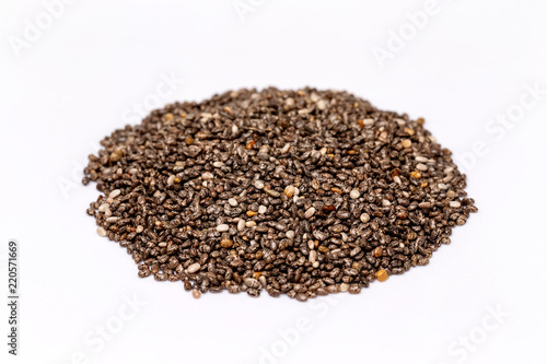 Macro image of chia superfood seeds pile isolated at white background. © Mayatnikstudio