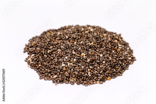 Macro image of chia superfood seeds pile isolated at white background.