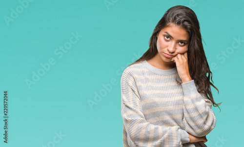 Young beautiful arab woman wearing winter sweater over isolated background thinking looking tired and bored with depression problems with crossed arms.