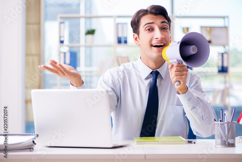 Quadro su tela Businessman with loudspeaker in the office