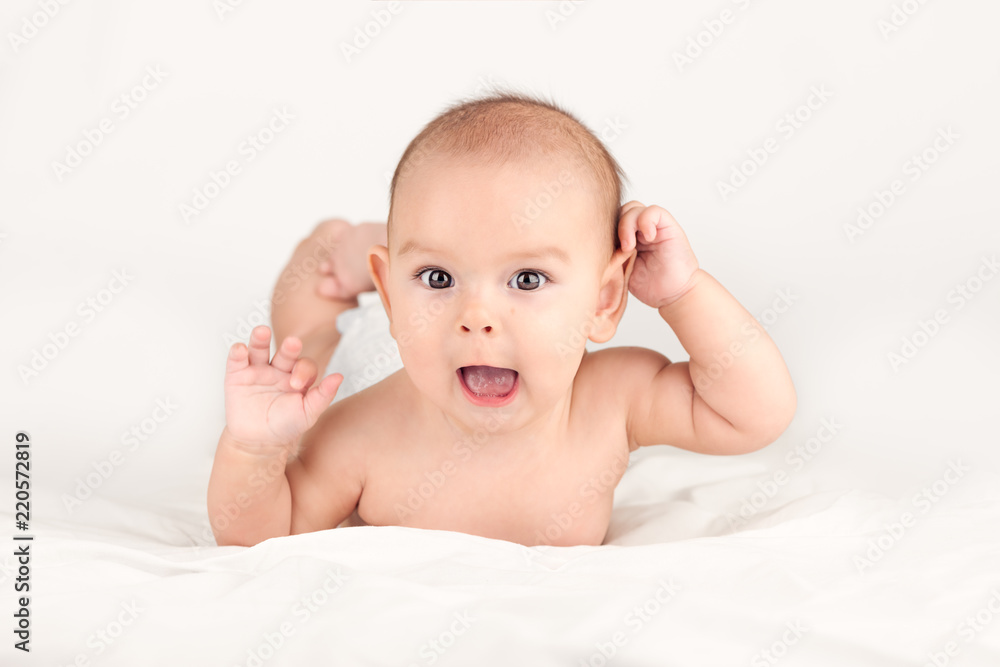 smiling happy newborn infant baby tummy time on bed bright airy copy smiling happy newborn infant baby tummy time on bed bright airy copy