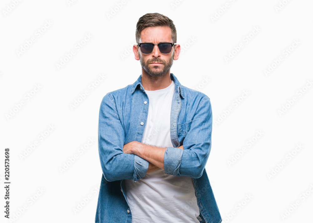 Young handsome man wearing sunglasses over isolated background skeptic and nervous, disapproving expression on face with crossed arms. Negative person. Young handsome man wearing sunglasses over isolated background skeptic and nervous, disapproving expression on face with crossed arms. Negative person.
