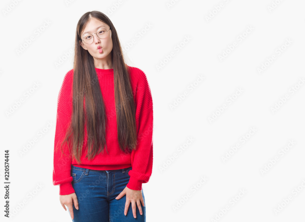 Obraz premium Young Chinese woman over isolated background wearing glasses making fish face with lips, crazy and comical gesture. Funny expression.