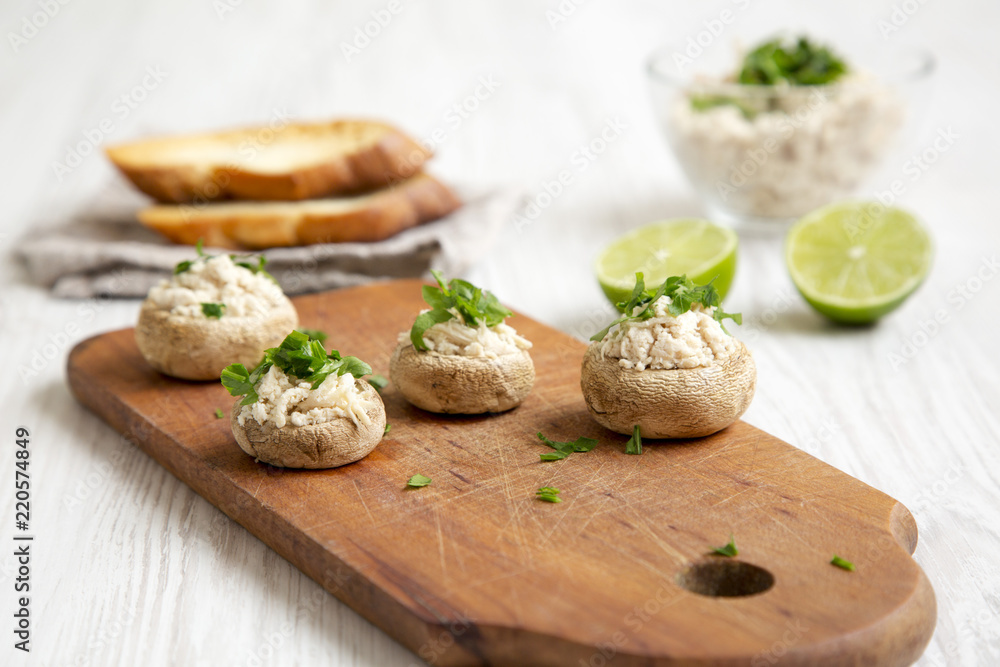 Mushroom and chicken puree with lime and toasts over white wooden surface, side view. Closeup. Selective focus. Mushroom and chicken puree with lime and toasts over white wooden surface, side view. Closeup. Selective focus.