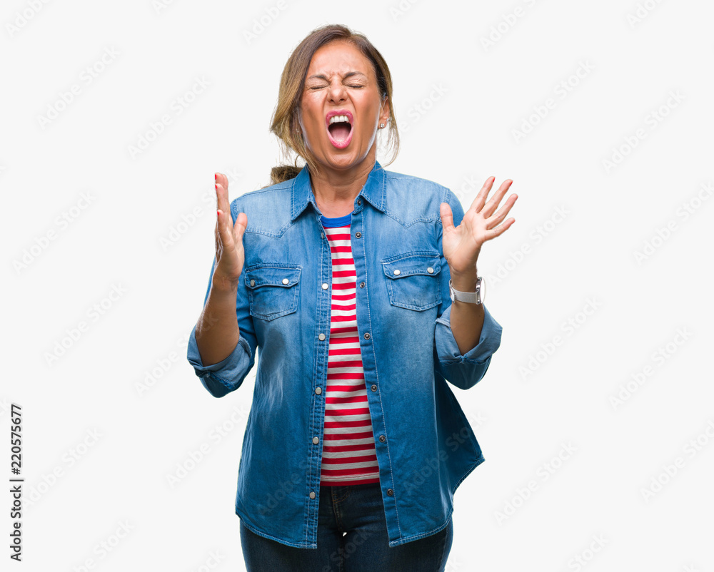 Middle age senior hispanic woman over isolated background crazy and mad shouting and yelling with aggressive expression and arms raised. Frustration concept. Middle age senior hispanic woman over isolated background crazy and mad shouting and yelling with aggressive expression and arms raised. Frustration concept.