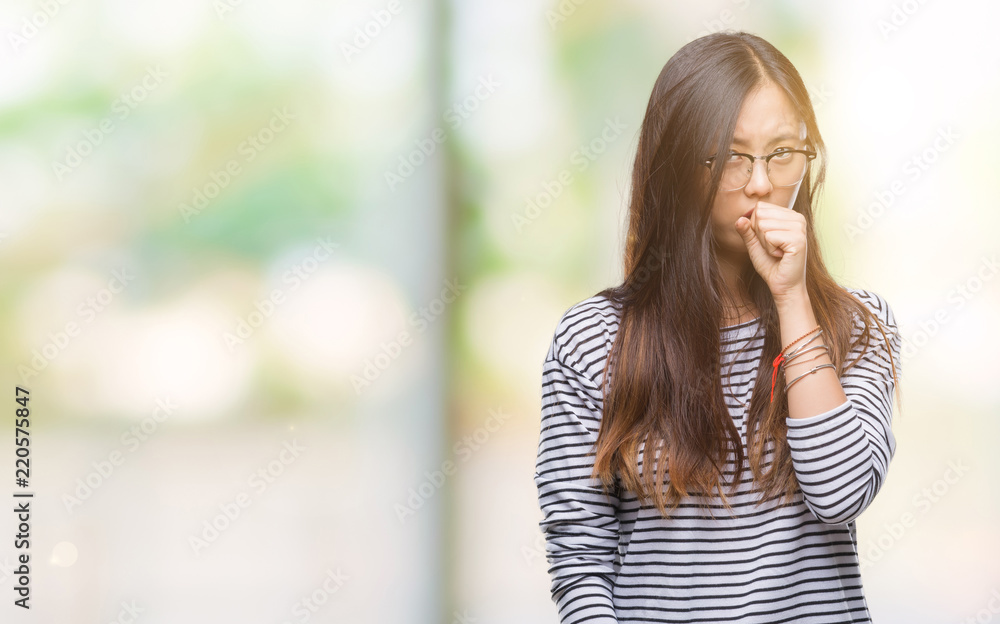 Young asian woman wearing glasses over isolated background feeling unwell and coughing as symptom for cold or bronchitis. Healthcare concept.