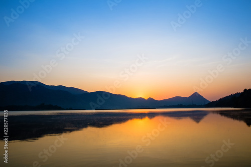 Wonderful the lake with sunrise in the evening. attractively nature landscape of golden lake and lagoon. image for background, wallpaper, copy space, decorate and arts.