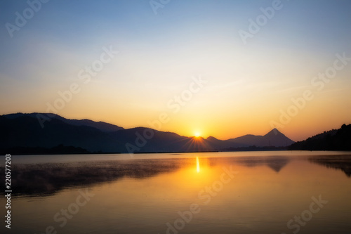 Wonderful the lake with sunrise in the evening. attractively nature landscape of golden lake and lagoon. image for background  wallpaper  copy space  decorate and arts.
