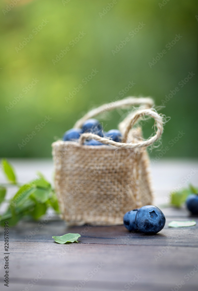 Fresh ripe sweep tasty blueberries outdoors on wood