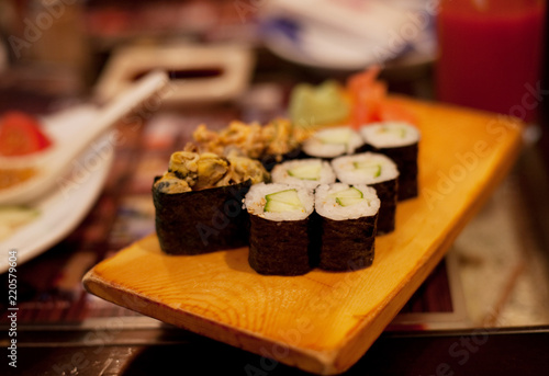 served maki rolls on wooden plate 