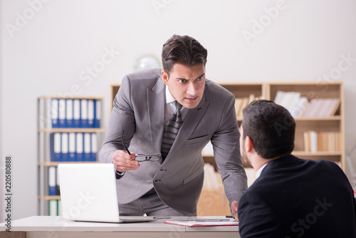 Angry boss shouting at his employee
