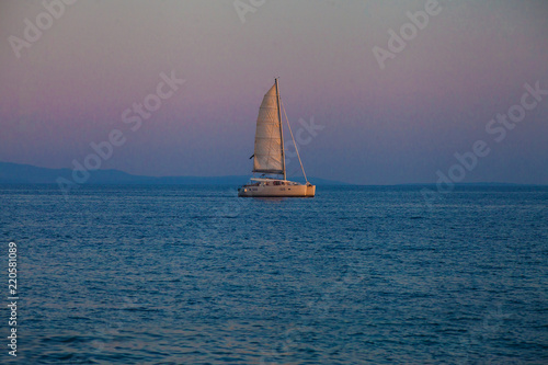 Catamatan yacht in sunset light
