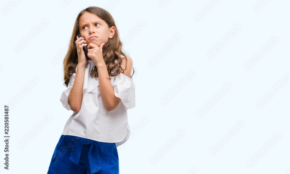 Brunette hispanic girl using smartphone serious face thinking about question, very confused idea Brunette hispanic girl using smartphone serious face thinking about question, very confused idea