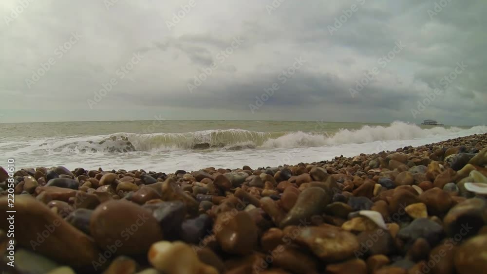 View of a winter sea with big furious waves in a very slow motion shot. Brighton, south England coast, Uk. View of a winter sea with big furious waves in a very slow motion shot. Brighton, south England coast, Uk.